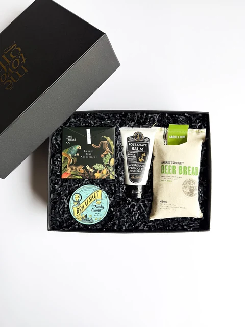 Black men's grooming gift box with body-care products and accessories