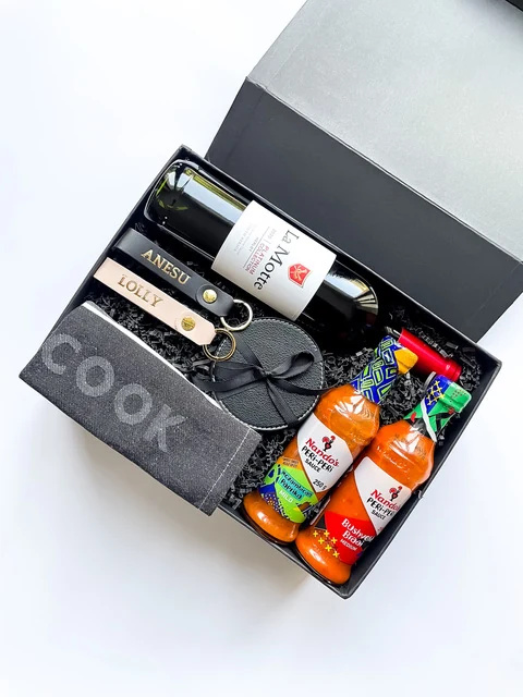 Black cooking gift box with sauces, snacks and personalised cook's apron